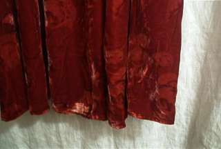   the shirt is made with a solid red rayon silk blend velour it has a