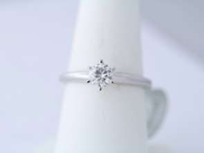 This ring is 14k white gold and it weighs 2.7 grams. It is a size 6 1 