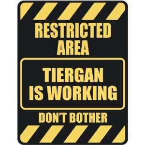   RESTRICTED AREA TIERGAN IS WORKING  PARKING SIGN